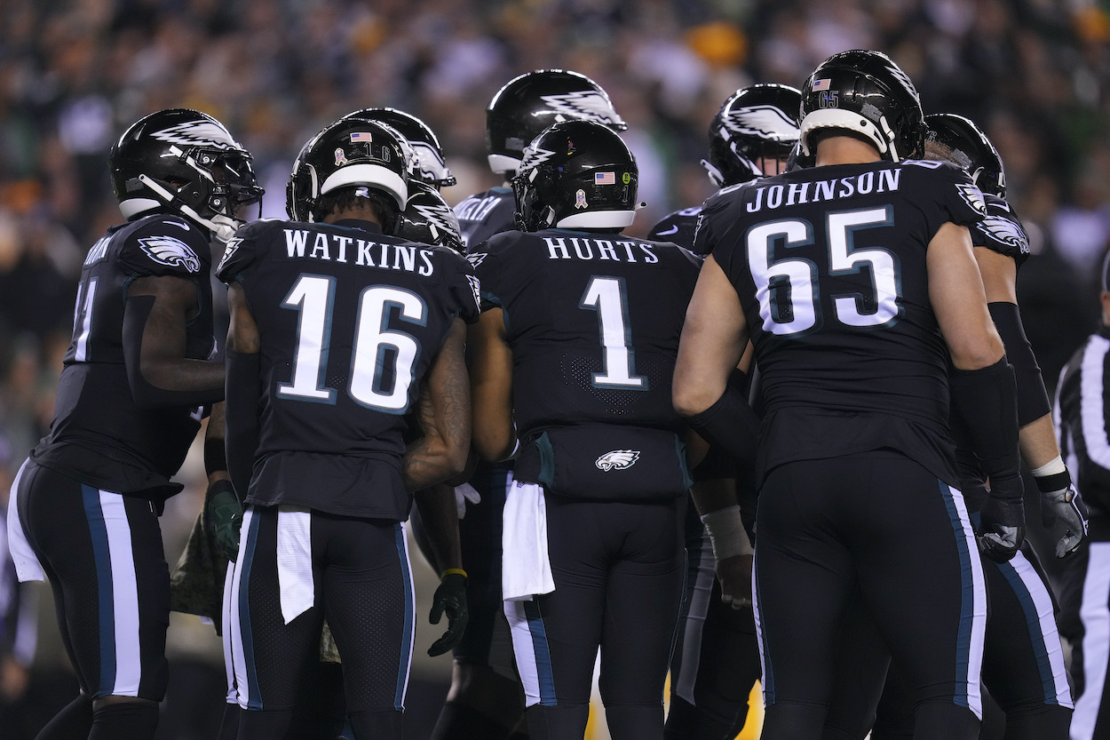 The Philadelphia Eagles huddle against the Green Bay Packers.