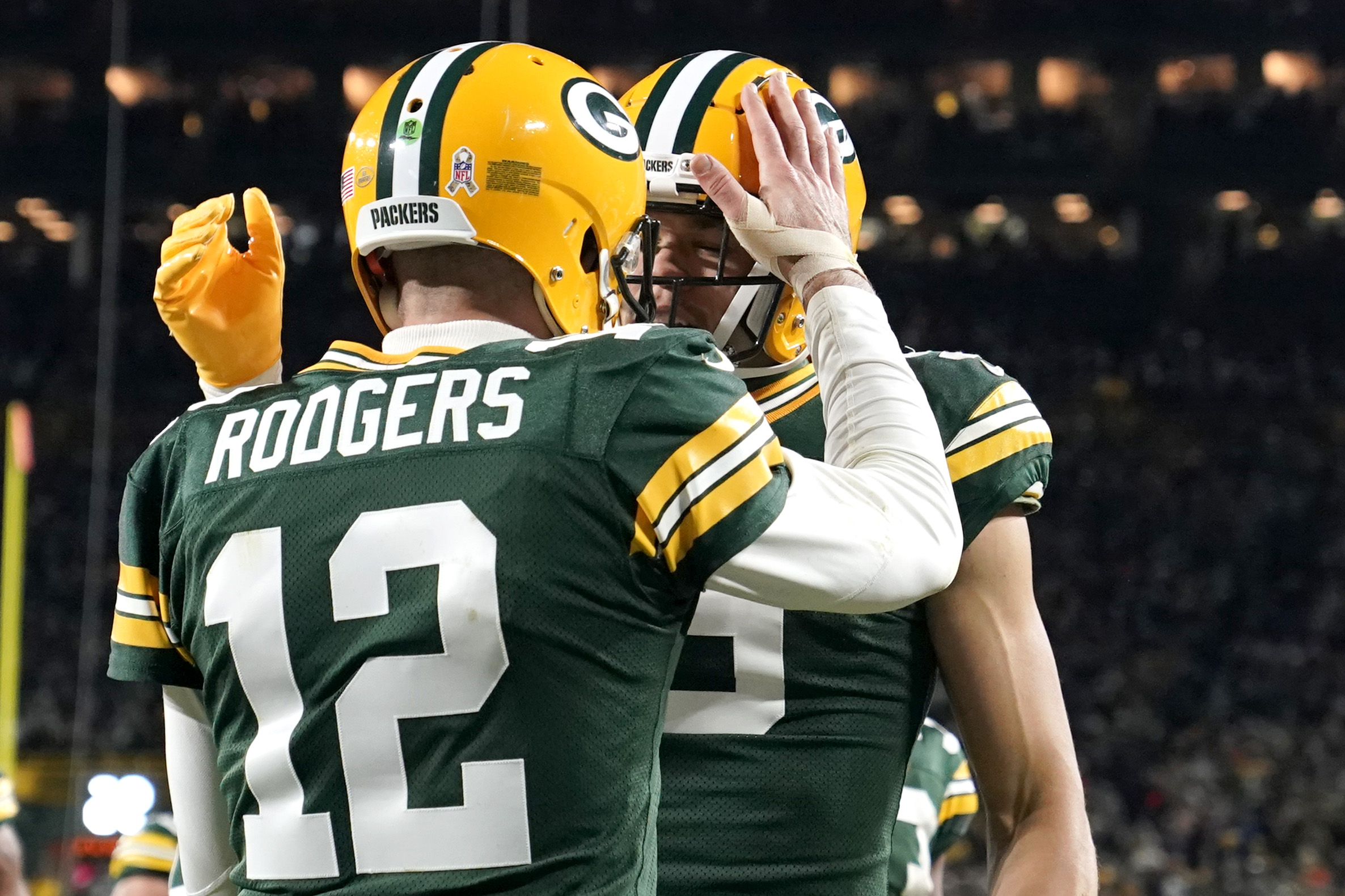 Aaron Rodgers of the Green Bay Packers celebrates with Christian Watson.