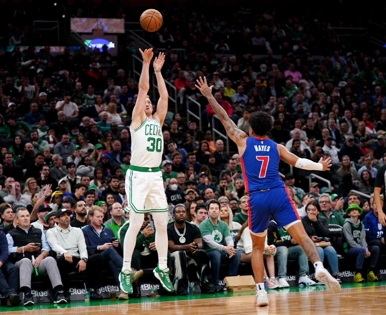 Sam Hauser of the Boston Celtics shoots the ball against Killian Hayes of the Detroit Pistons.
