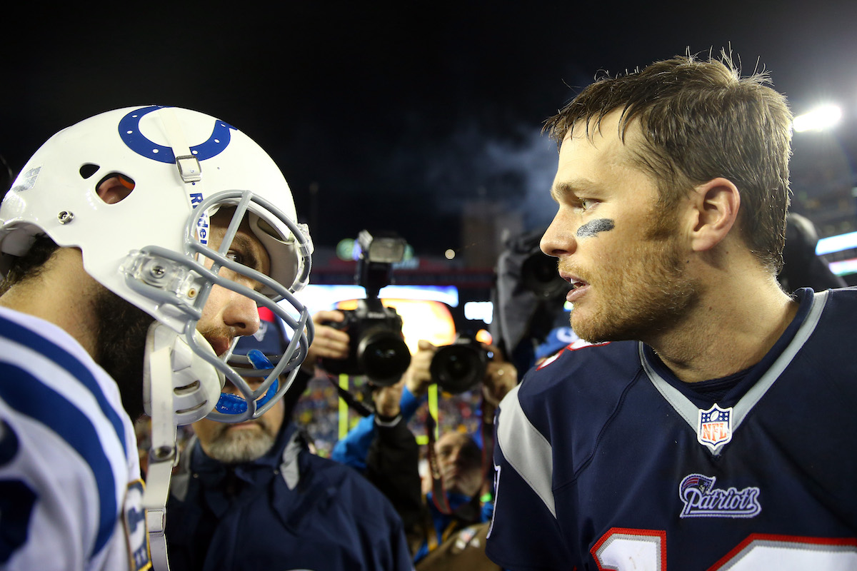 Quarterbacks Tom Brady and Andrew Luck shake hands after the AFC Divisional Playoff game in 2014
