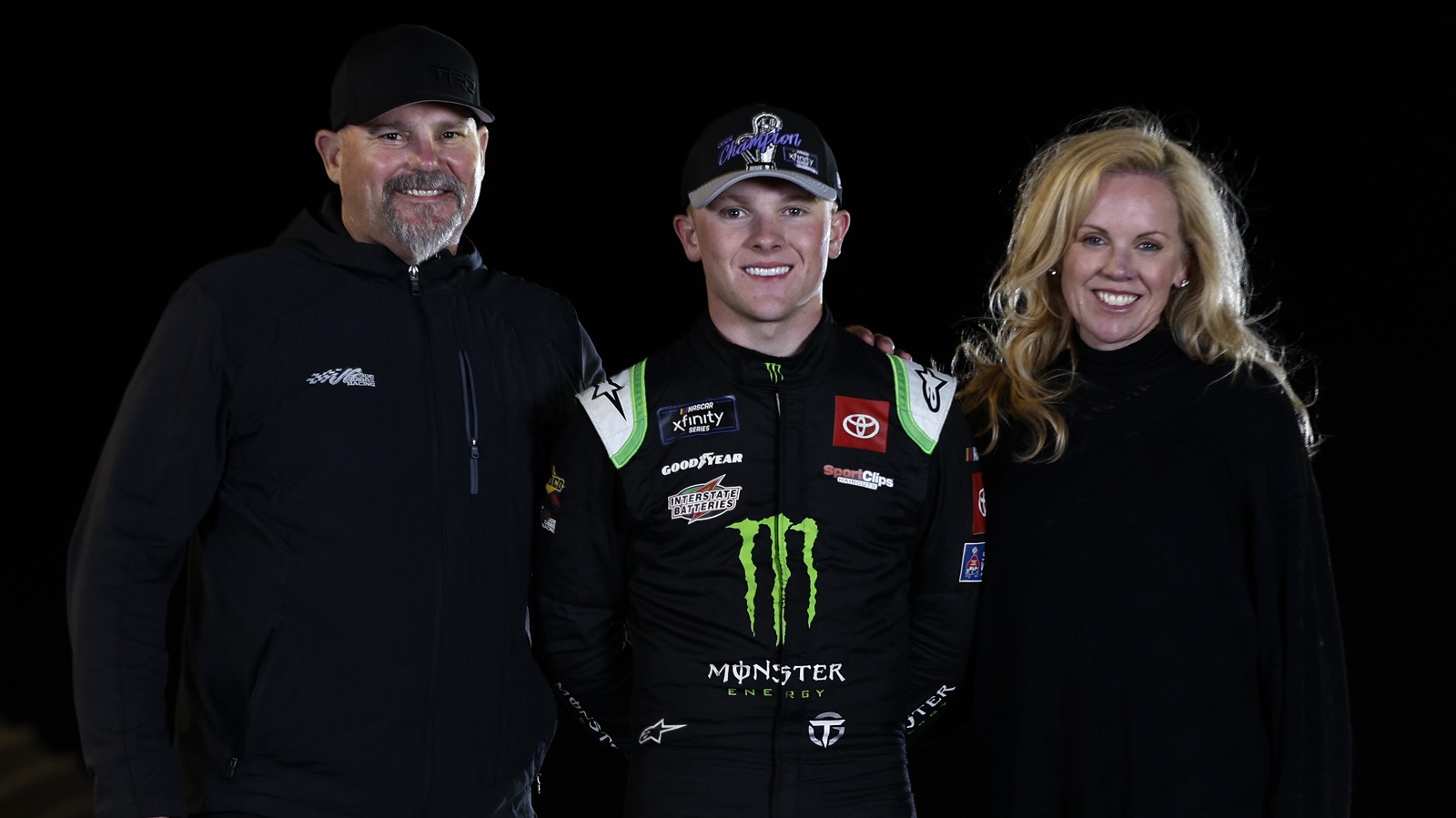 Ty Gibbs poses with his father, Coy Gibbs and mother, Heather Gibbs after winning the NASCAR Xfinity Series championship at Phoenix Raceway on Nov. 5, 2022.