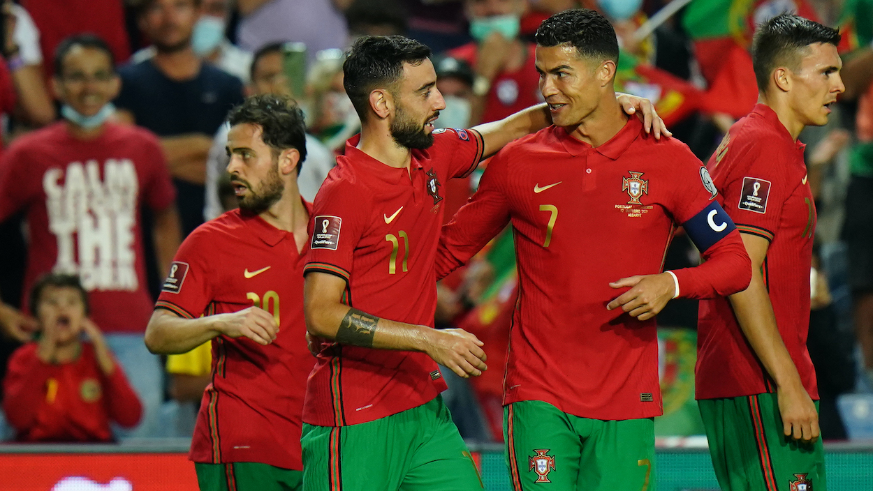 Bruno Fernandes of Portugal celebrates with teammate Cristiano Ronaldo after scoring a goal during the 2022 FIFA World Cup Qualifier match between Portugal and Luxembourg at Estadio Algarve on October 12, 2021 in Loule, Portugal. World Cup 2022