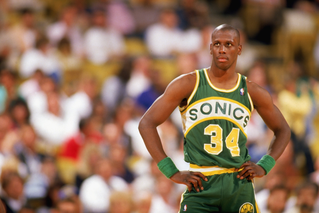 Xavier McDaniel of the Seattle Supersonics looks on.