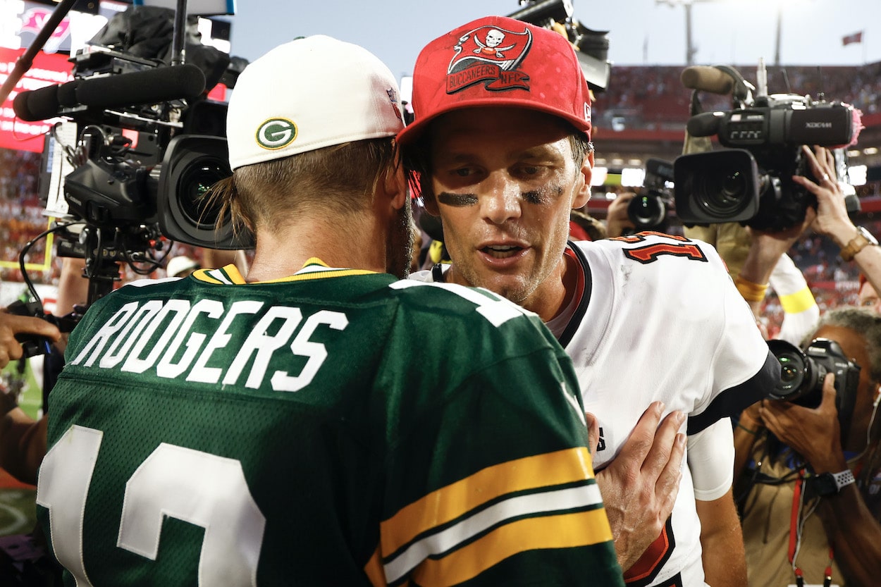 Aaron Rodgers and Tom Brady embrace after a game.