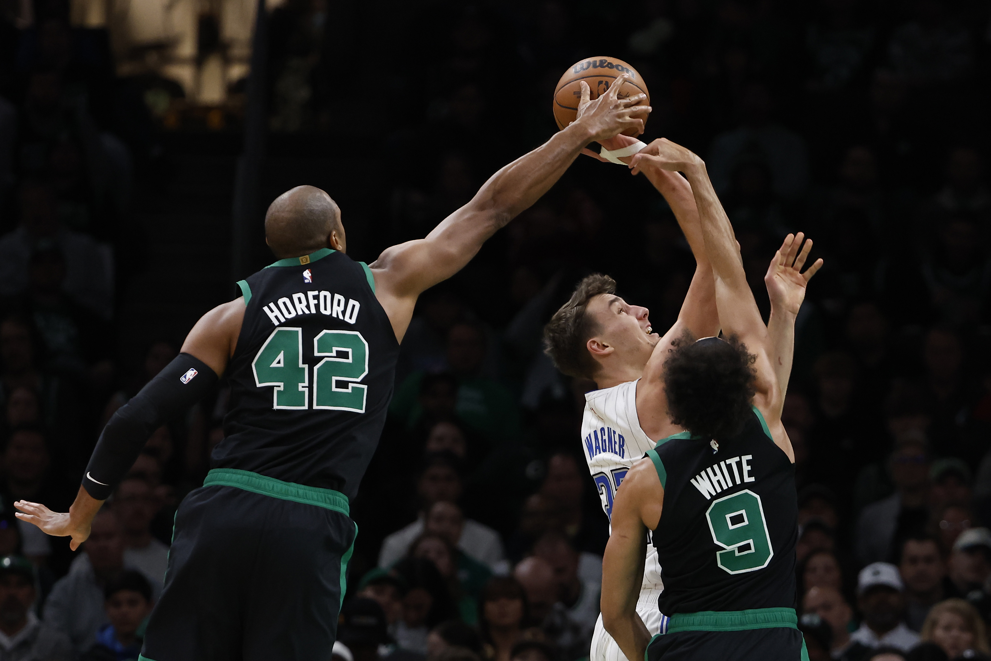 Al Horford of the Boston Celtics blocks a shot by Franz Wagner of the Orlando Magic.