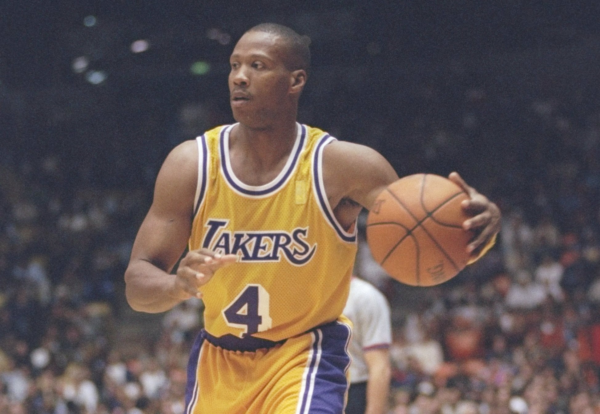 Guard Byron Scott of the Los Angeles Lakers dribbles the ball down the court.