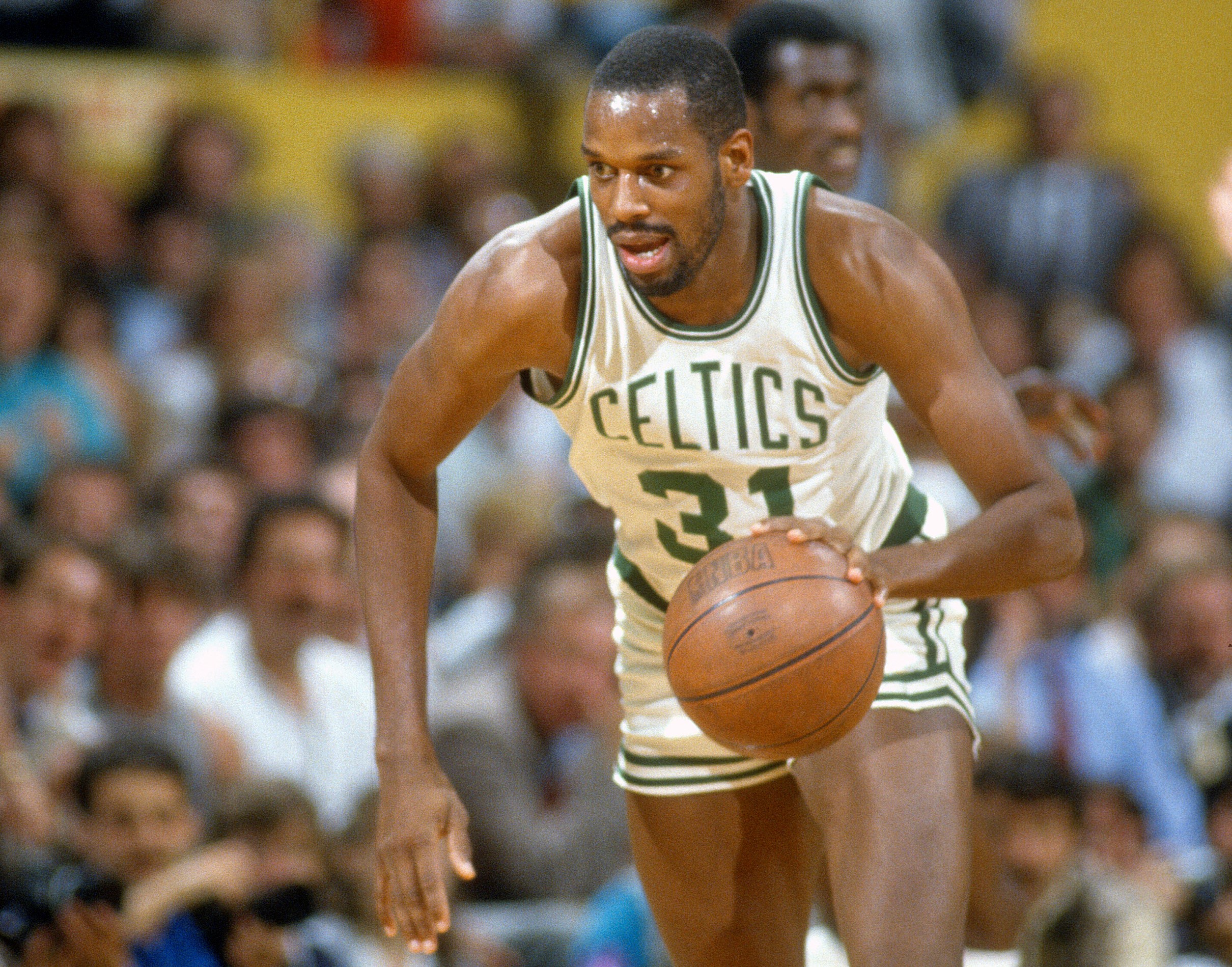Cedric Maxwell of the Boston Celtics dribbles the ball up court.