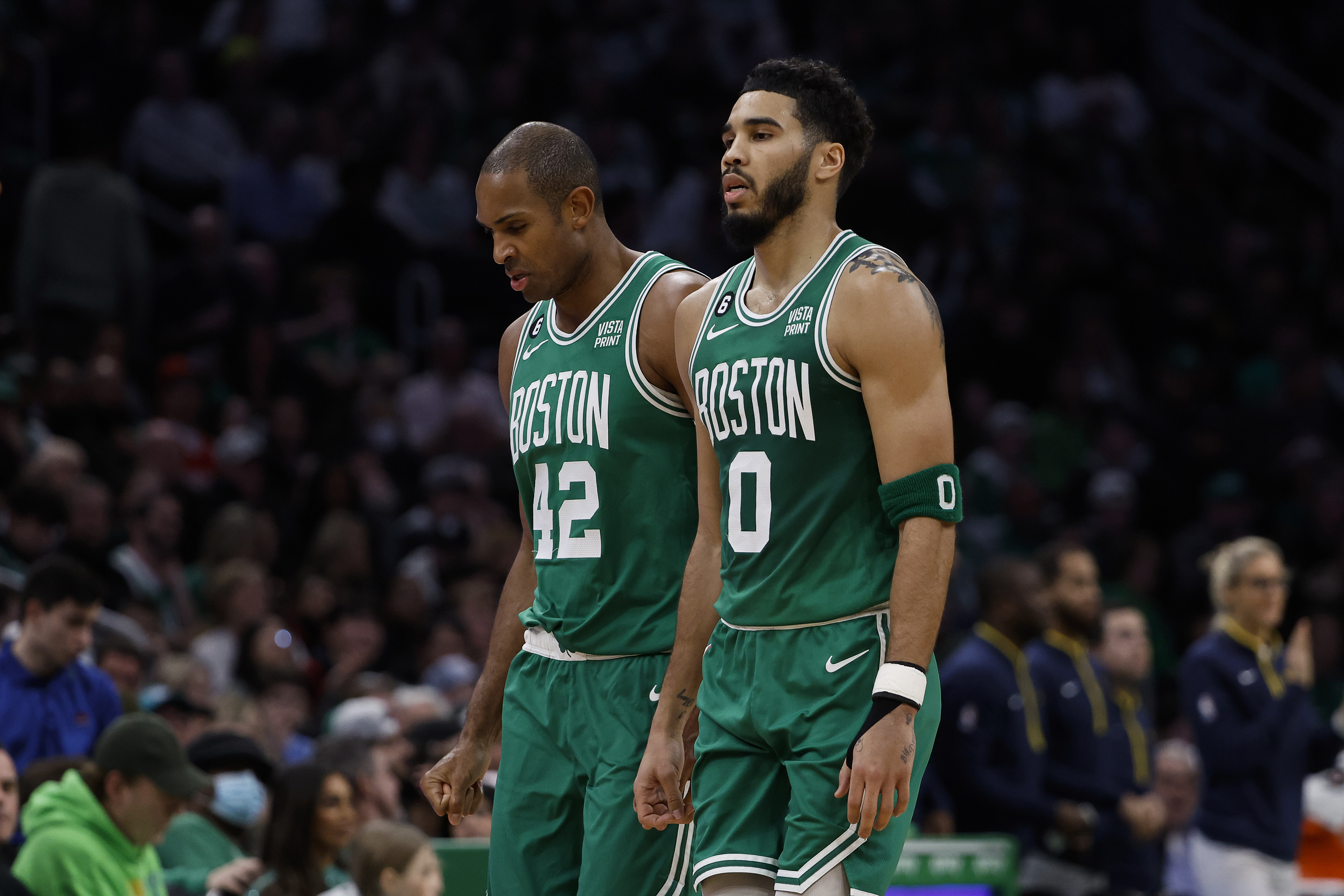 Jayson Tatum and Al Horford of the Boston Celtics walk off the court.