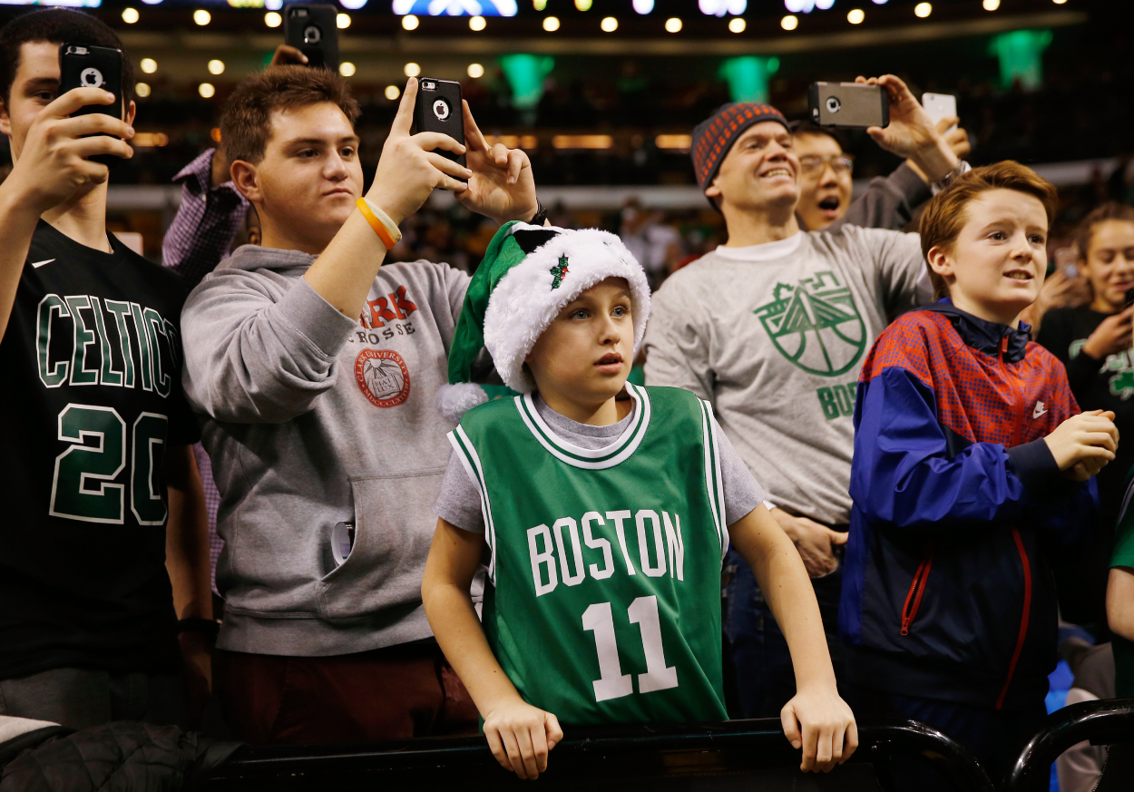 A young Boston Celtics fan wears a Santa hat to the Christmas Day game in Boston.