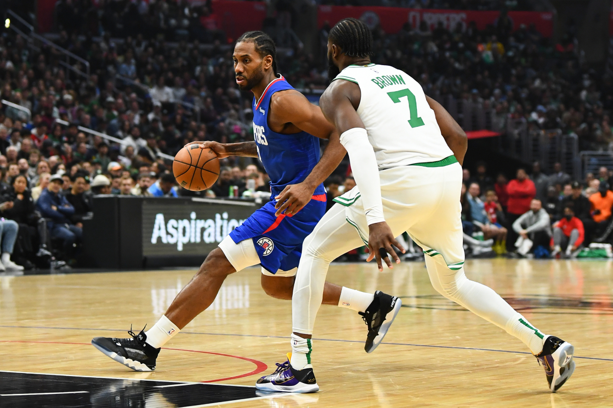 Los Angeles Clippers Forward Kawhi Leonard drives past Boston Celtics guard Jaylen Brown.