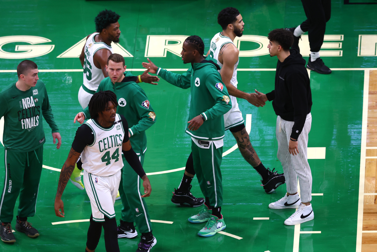 Marcus Smart, Robert Williams III, and Jayson Tatum of the Boston Celtics celebrate with teammates.
