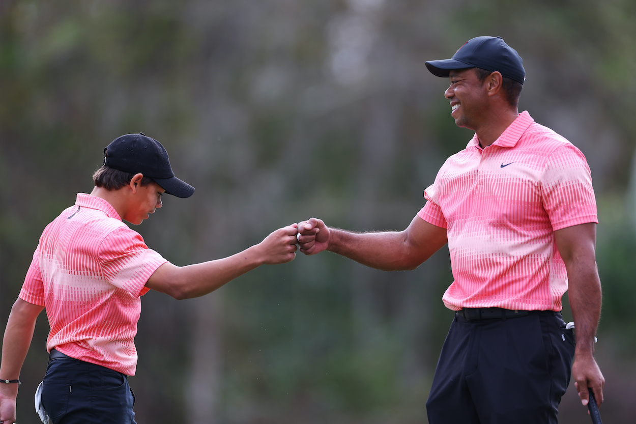 Tiger Woods and Charlie Woods fist bump during the PNC Championship.