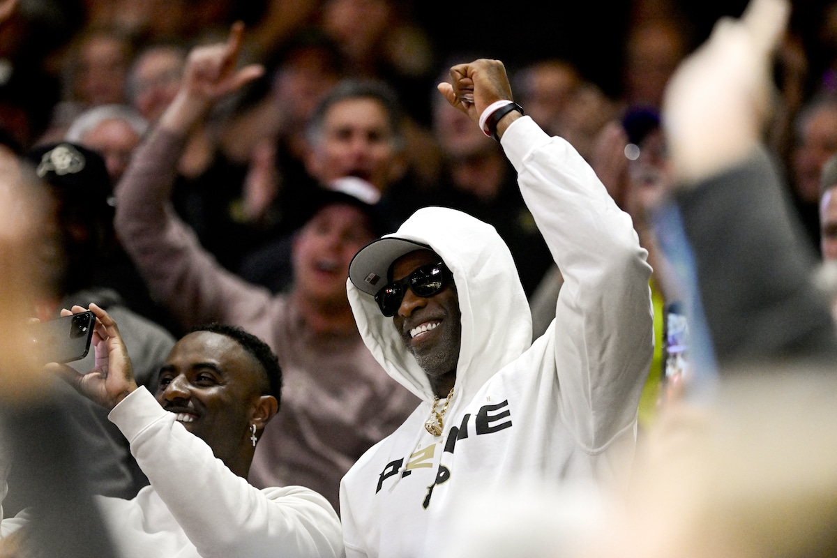 Colorado Buffaloes head football coach Deion Sanders cheers on the basketball team