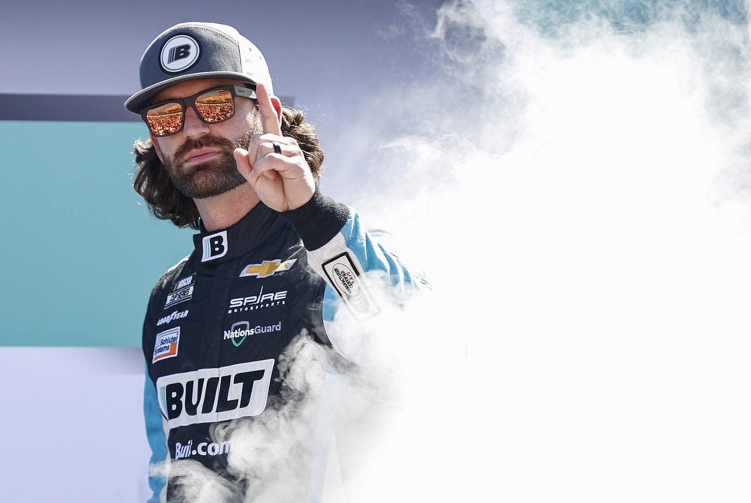 Corey LaJoie waves to fans as he walks onstage during driver intros prior to the NASCAR Cup Series Dixie Vodka 400 at Homestead-Miami Speedway on Oct. 23, 2022.