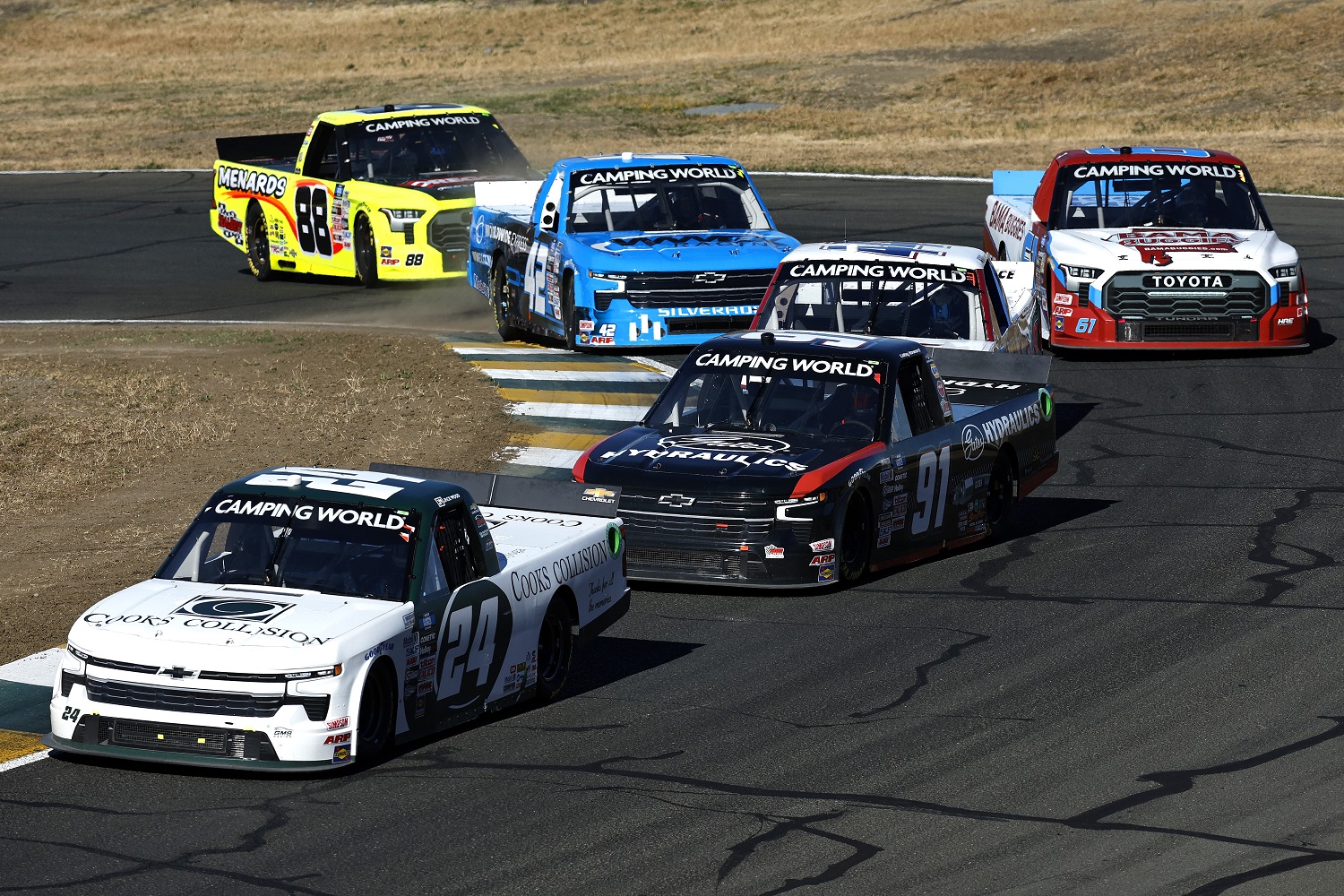 Jack Wood and Colby Howard lead the pack through a turn during the NASCAR Camping World Truck Series DoorDash 250 at Sonoma Raceway on June 11, 2022.
