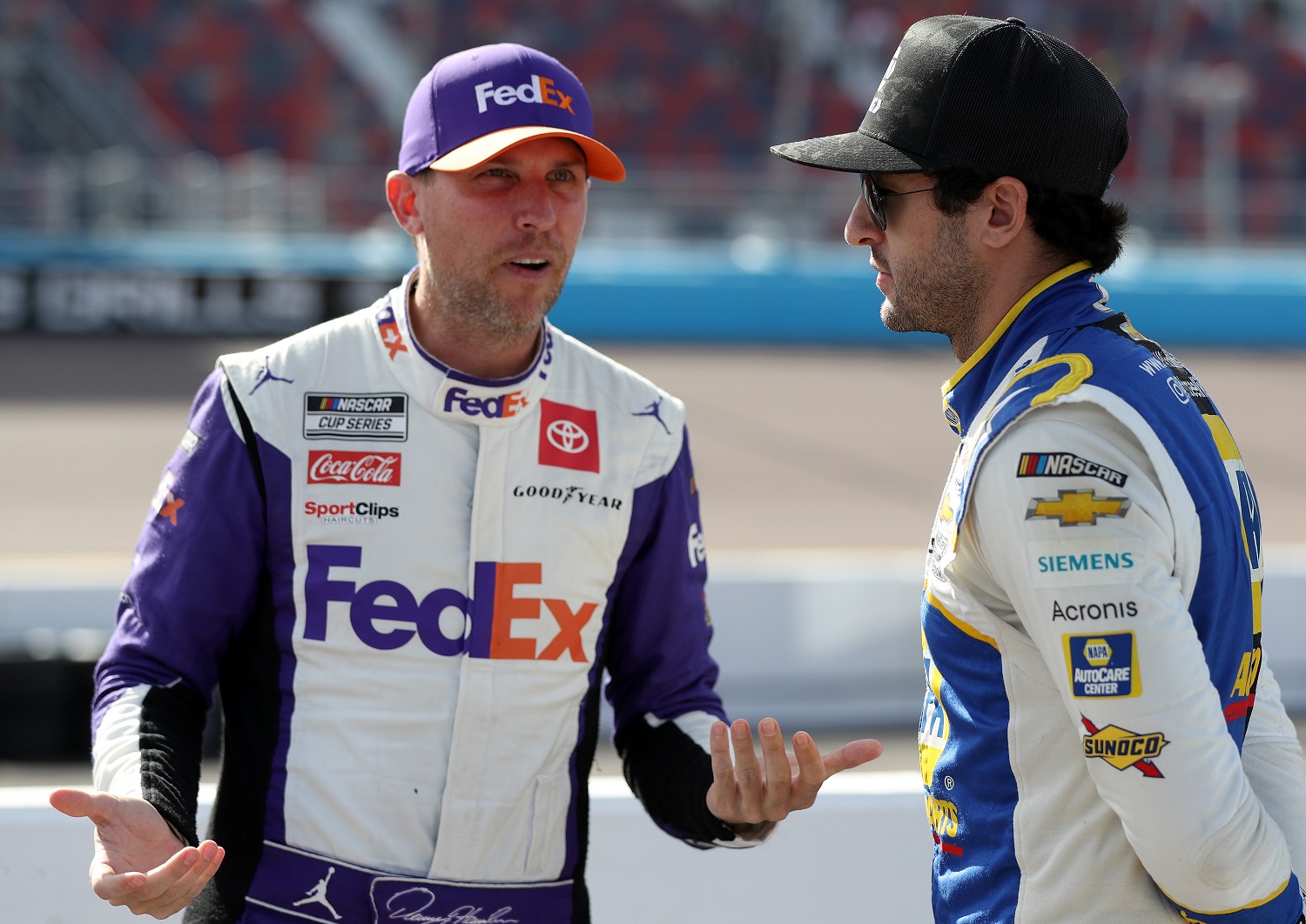 Denny Hamlin, left, talks with Chase Elliott during qualifying for the NASCAR Cup Series Championship at Phoenix Raceway on Nov. 5, 2022. | Meg Oliphant/Getty Images