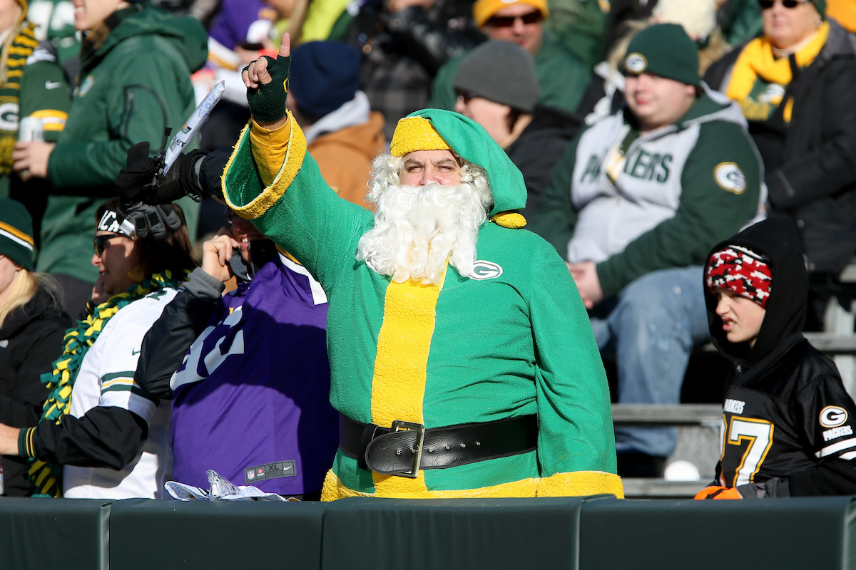 Fans dressed as Santa Claus poses for a picture before a Green Bay Packers game