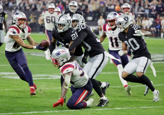 Wide receiver Jakobi Meyers of the New England Patriots catches a lateral pass from running back Rhamondre Stevenson.