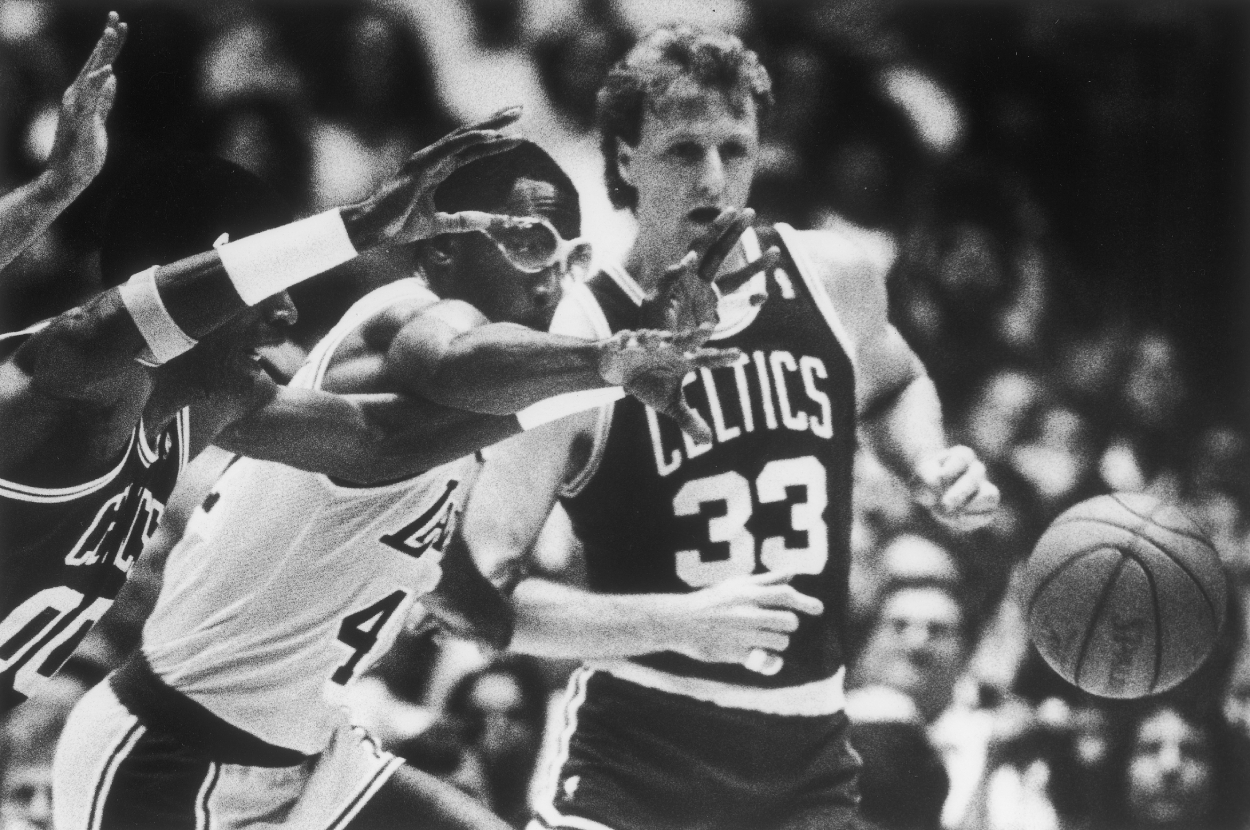 The Lakers' James Worthy and the Celtics Larry Bird go after a loose ball.