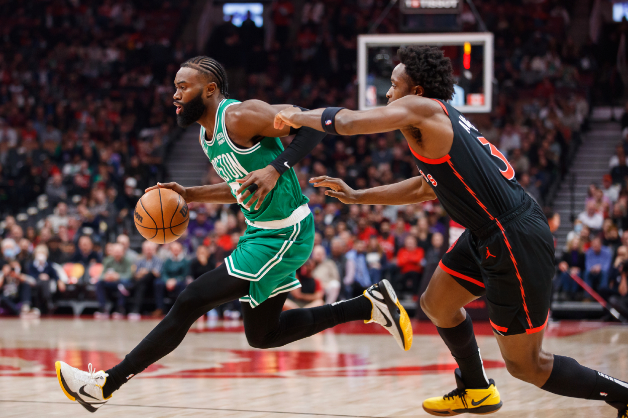 Jaylen Brown of the Boston Celtics dribbles by O.G. Anunoby of the Toronto Raptors.