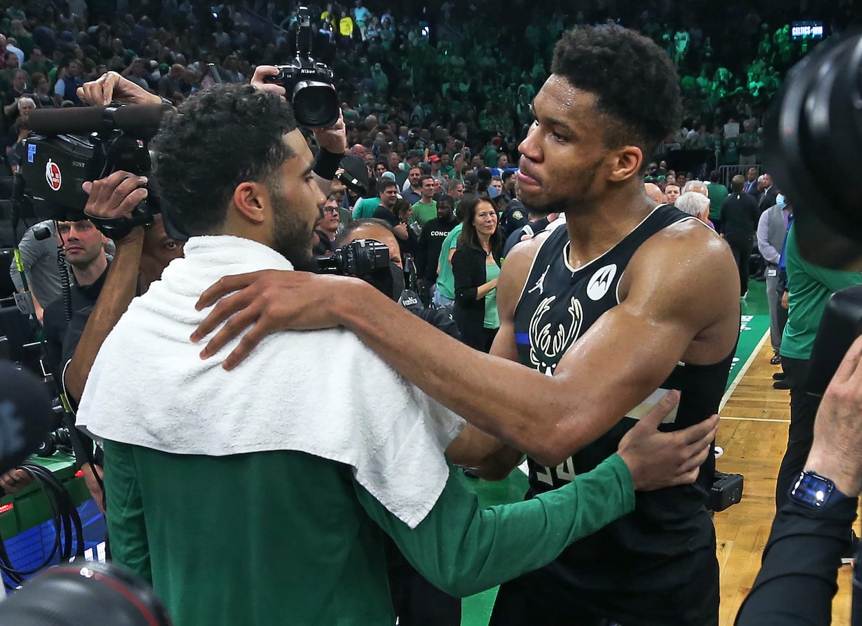 Jayson Tatum and Giannis Antetokounmpo talk after a game.