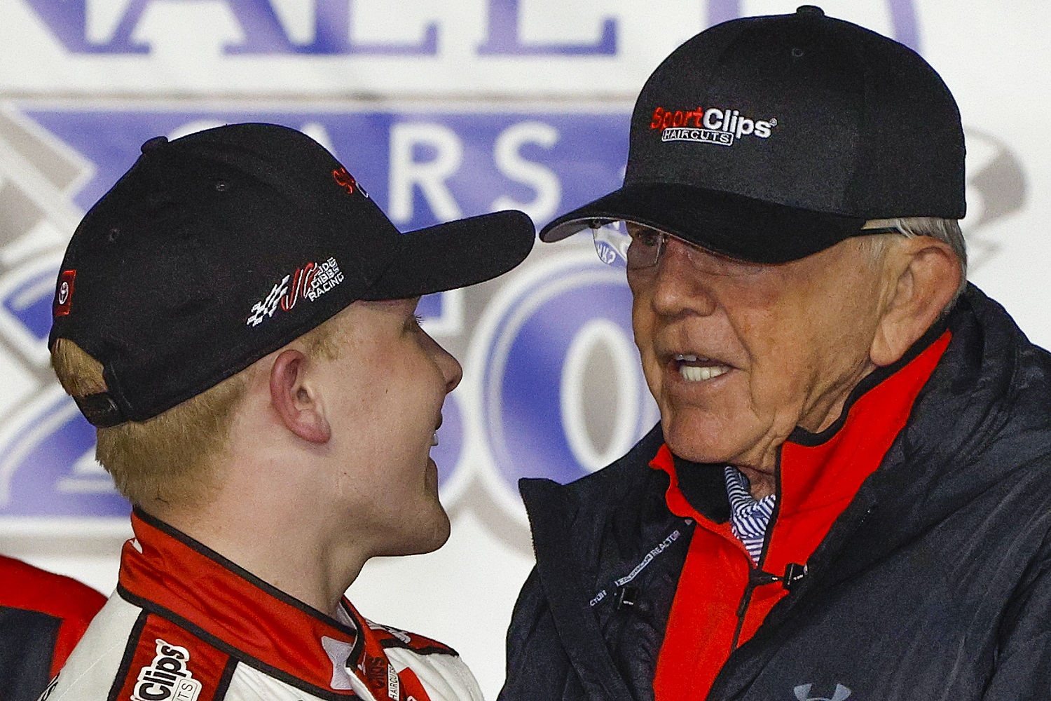 Ty Gibbs is congratulated by his grandfather and team owner Joe Gibbs in after winning the NASCAR Xfinity Series Nalley Cars 250 at Atlanta Motor Speedway on March 19, 2022.