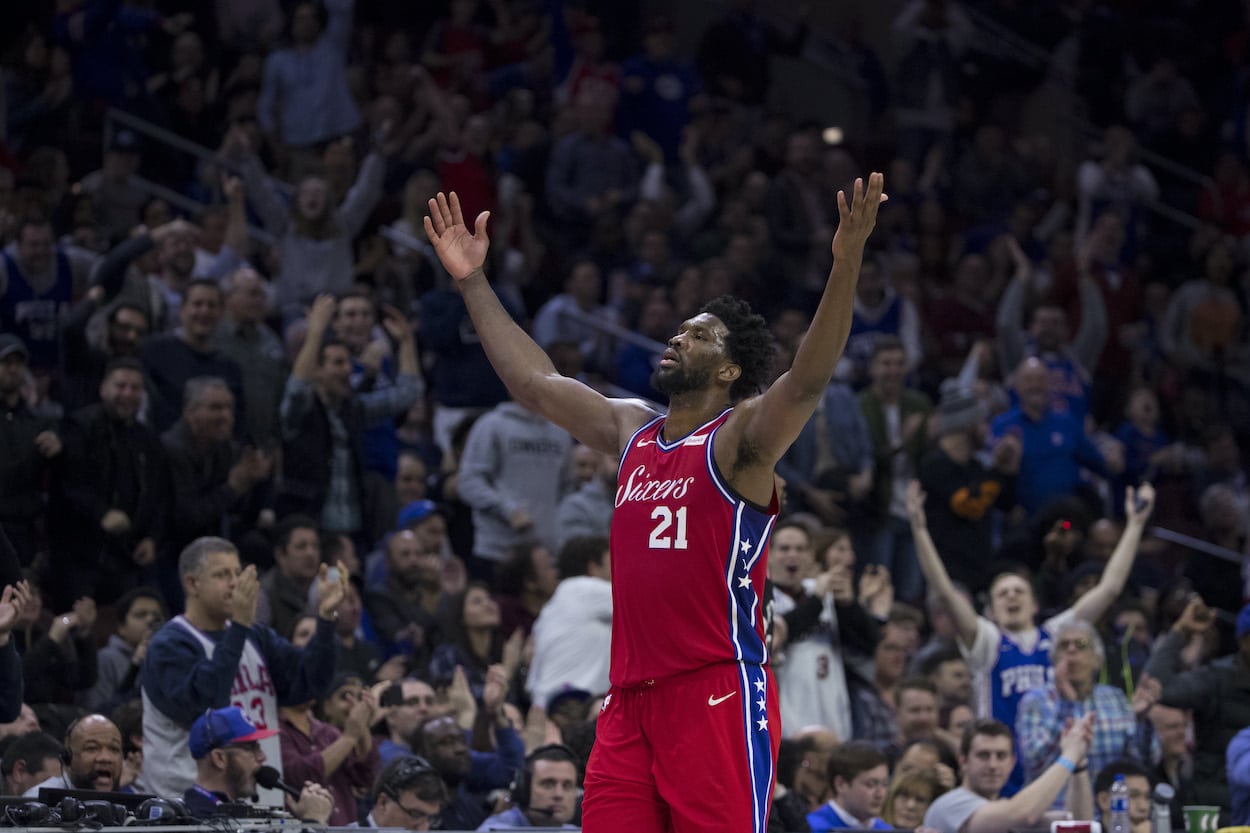 Joel Embiid encourages the crowd against the Raptors.