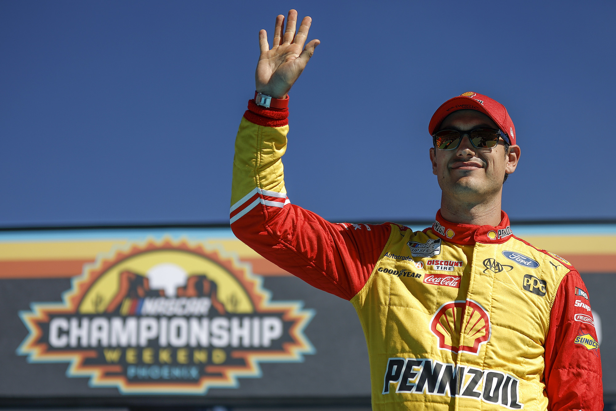 Joey Logano waves to fans