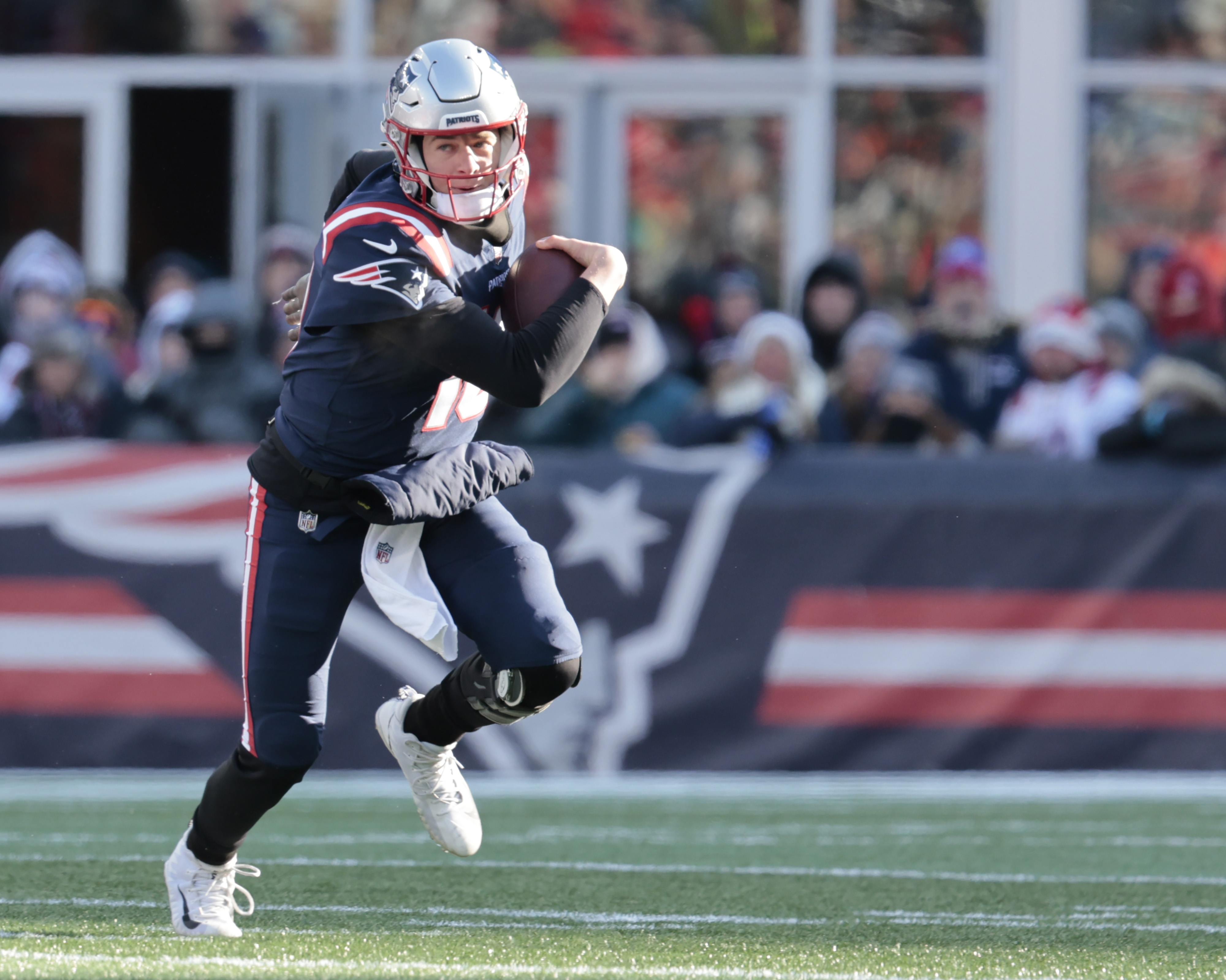 Mac Jones of the New England Patriots rushes the ball during the first quarter against the Cincinnati Bengals.