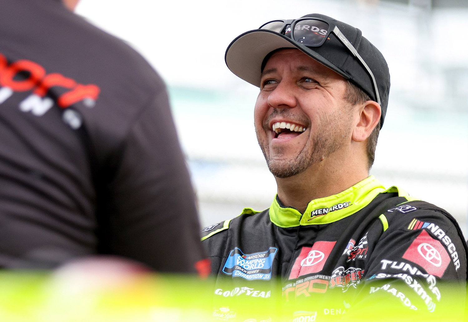 Matt Crafton shares a laugh with his crew on the grid during qualifying for the NASCAR Camping World Truck Series Baptist Health 200 at Homestead-Miami Speedway on Oct. 21, 2022.