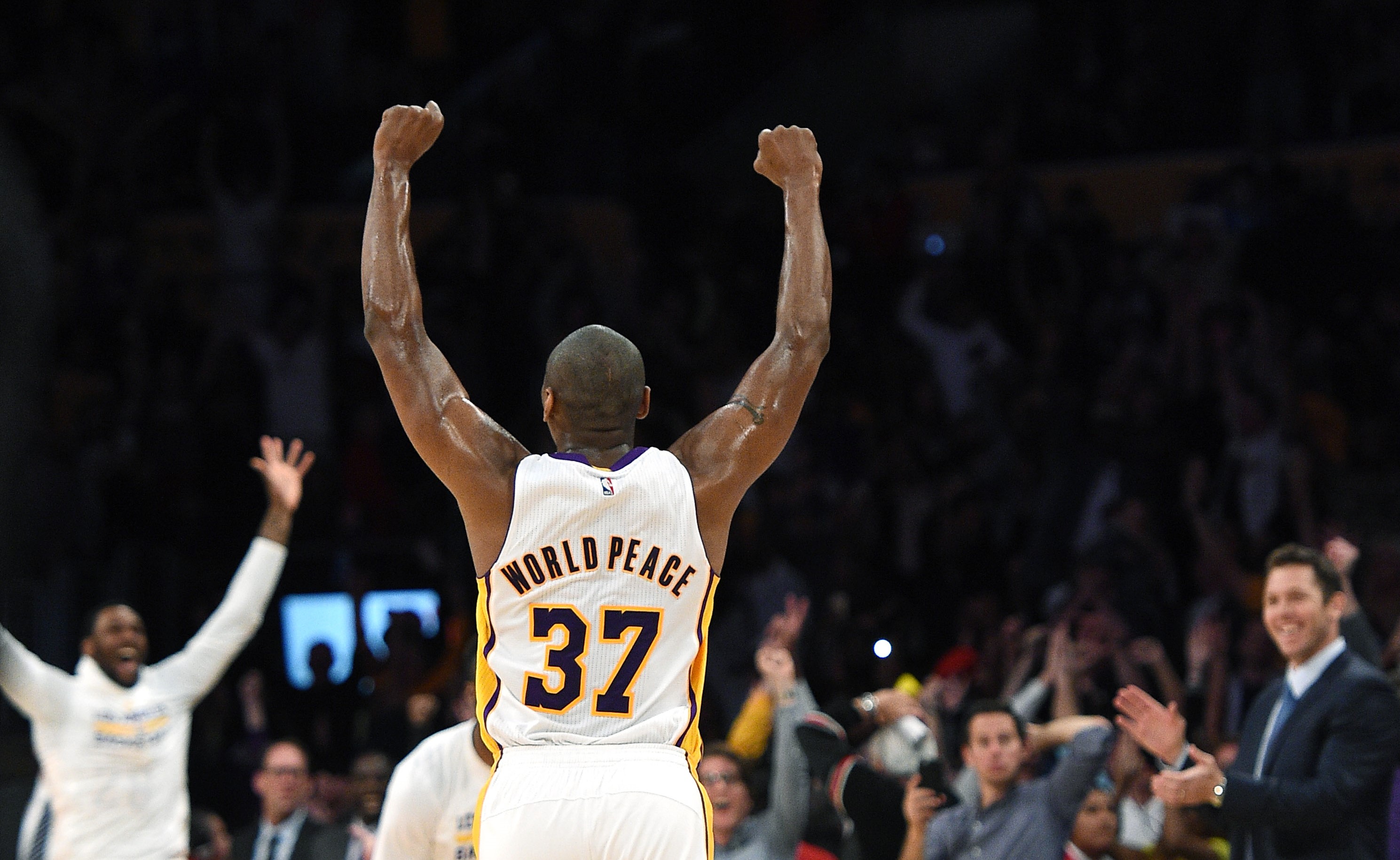 Metta World Peace of the Los Angeles Lakers celebrates the buzzer-beating three-point basket by teammate D'Angelo Russell.