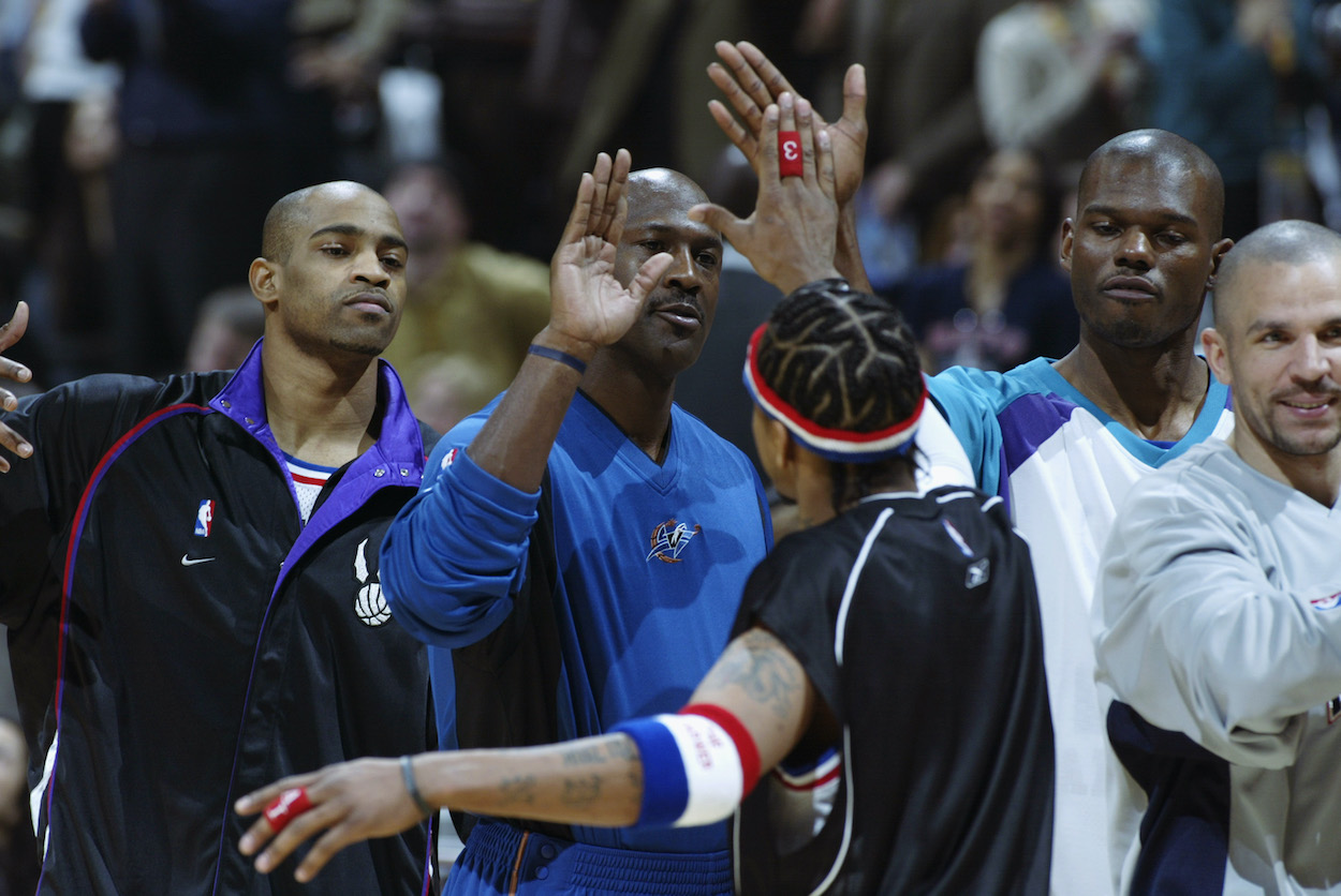 Michael Jordan and Allen Iverson high five.