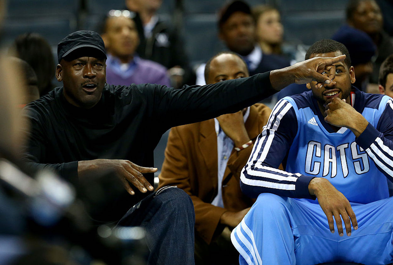 Michael Jordan sits on the sidelines during a Charlotte Bobcats game.