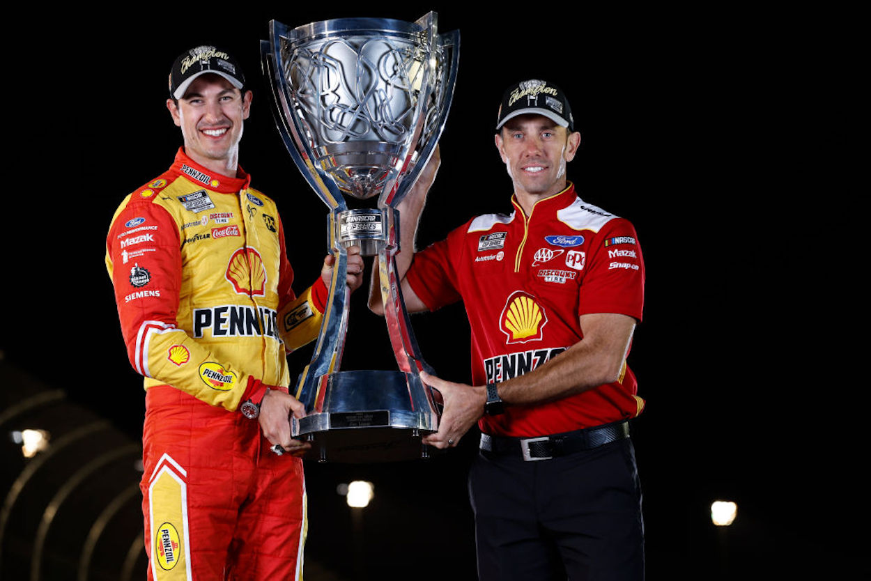 Crew Chief Paul Wolfe (R) poses with Joey Logano after claiming the NASCAR Cup Series title.