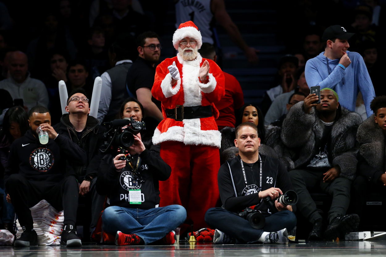 A fan dressed as Santa Claus attends the game between the Brooklyn Nets and the Denver Nuggets at Barclays Center on December 8, 2019, in New York City.