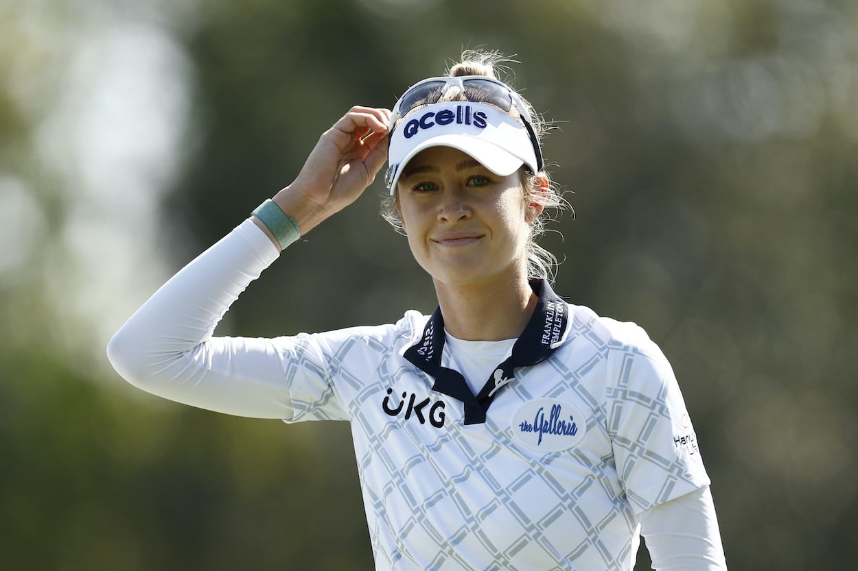 Nelly Korda smiles on the golf course.