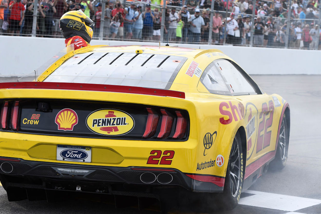 Joey Logano climbs out of his eam Penske NextGen Ford Mustang.