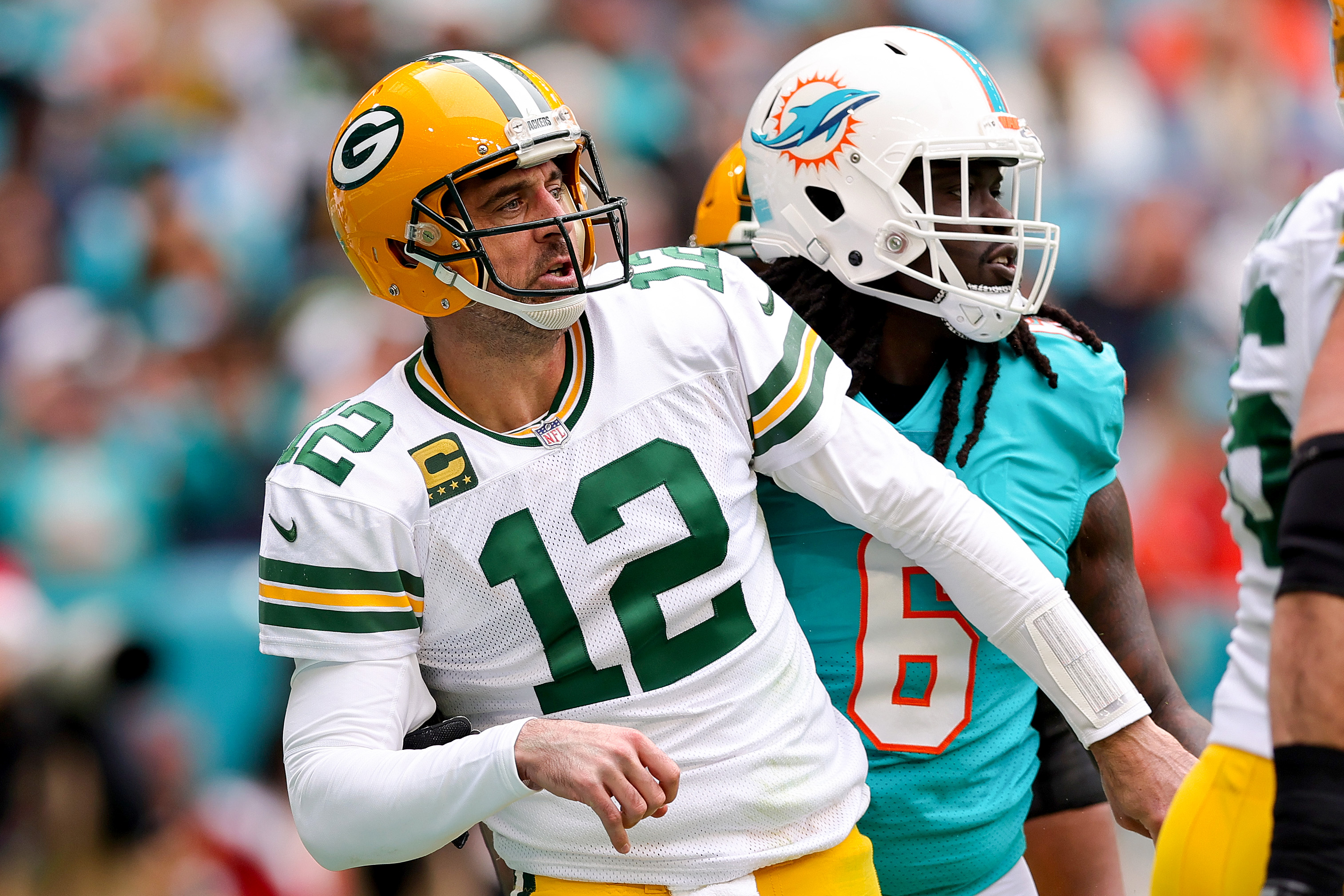 Aaron Rodgers of the Green Bay Packers reacts after throwing a pass against the Miami Dolphins.