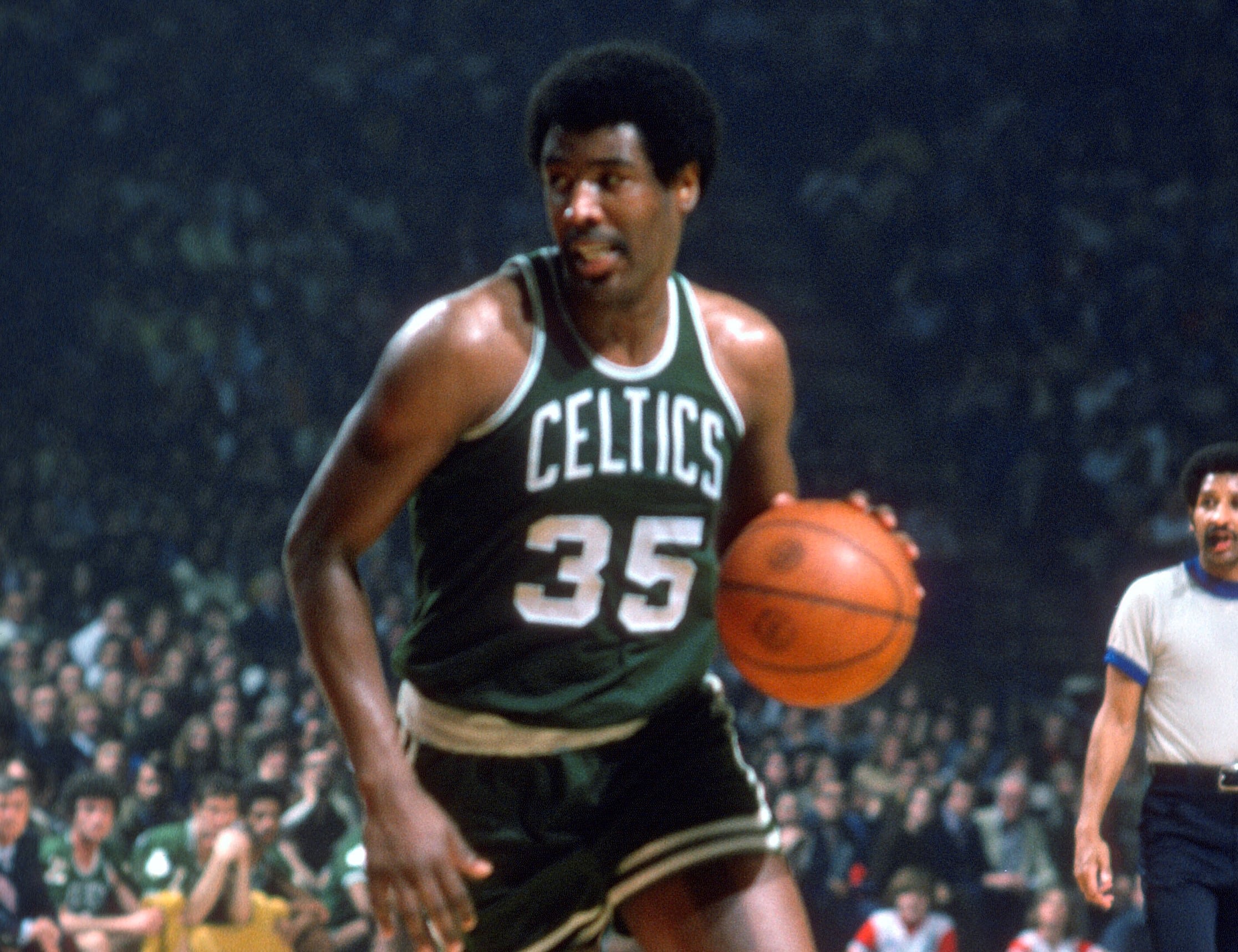 Paul Silas of the Boston Celtics dribbles the ball against the Washington Bullets.