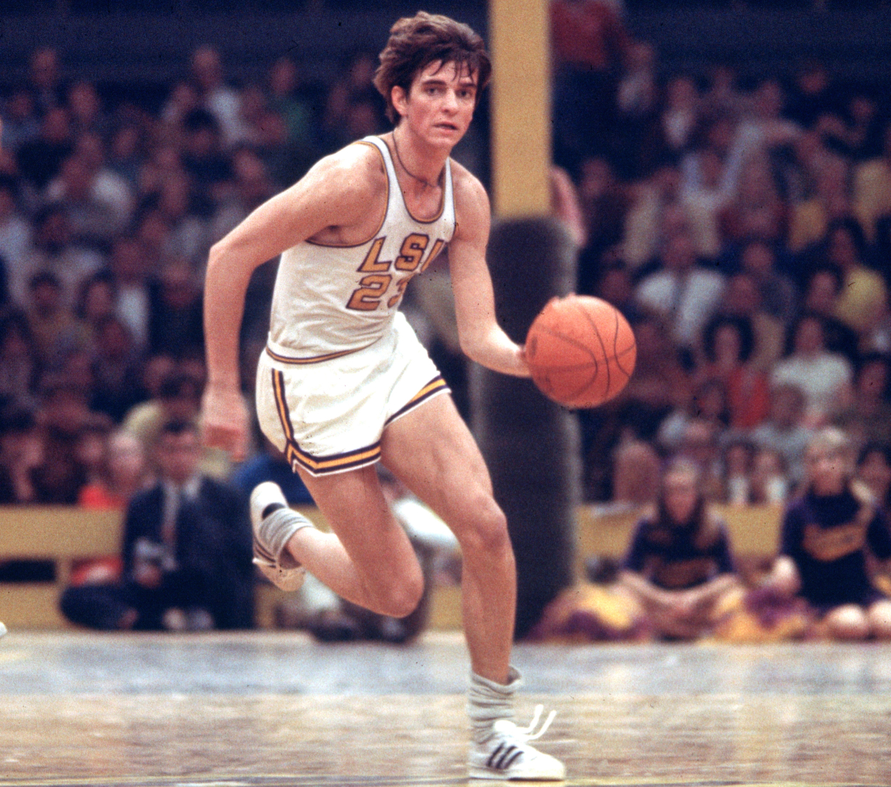 Pete Maravich of the LSU Tigers dribbles the ball.