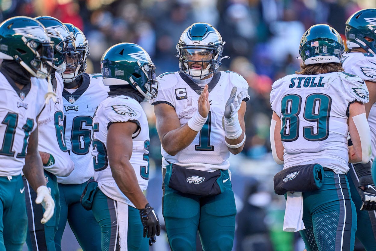 Jalen Hurts leads an Eagles huddle.