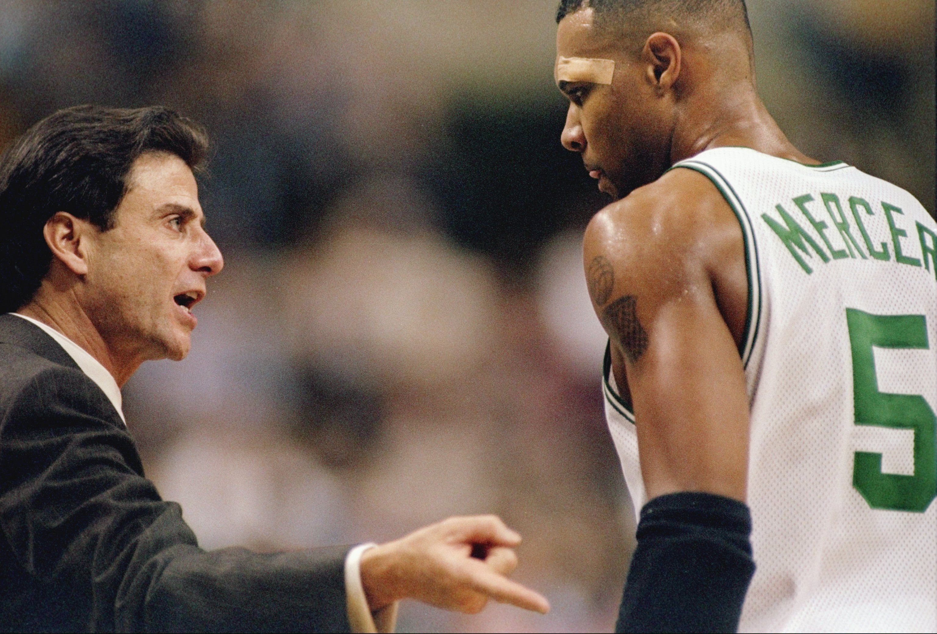 Head coach Rick Pitino of the Boston Celtics talks to his guard Ron Mercer.