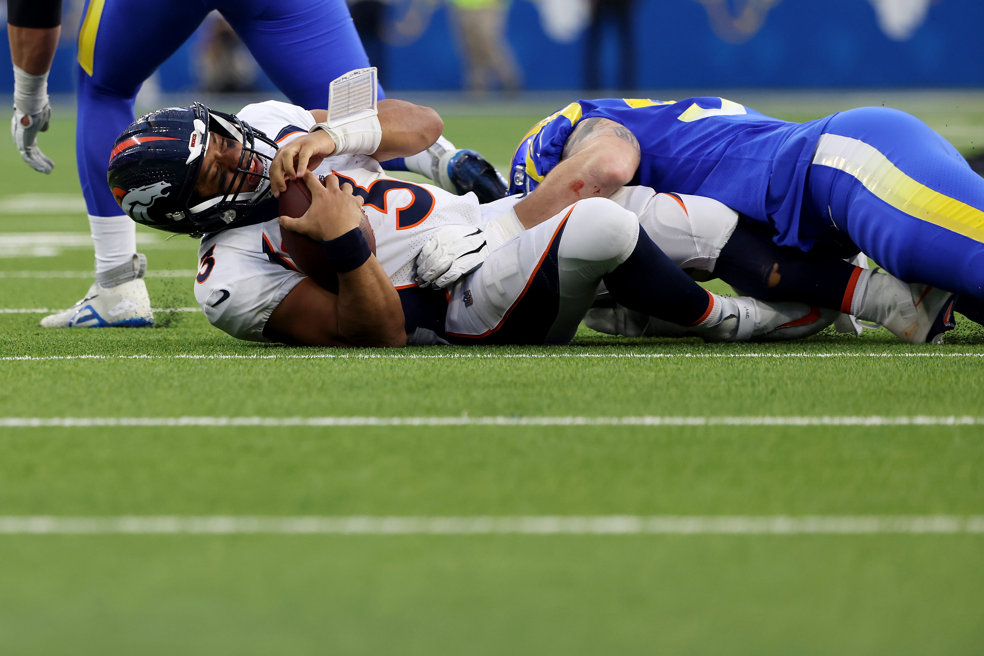 Michael Hoecht of the Los Angeles Rams sacks Russell Wilson of the Denver Broncos.