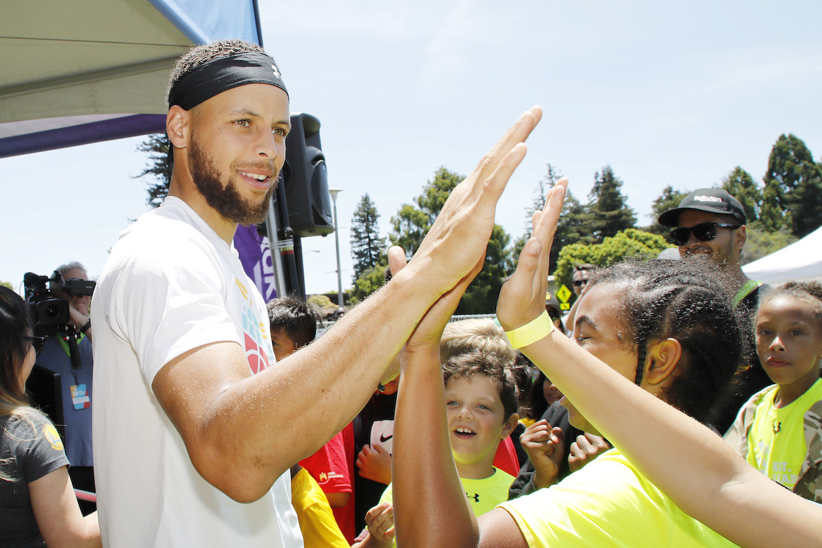 Stephen Curry greets kids at the launch of Eat. Learn. Play. Foundation in 2019