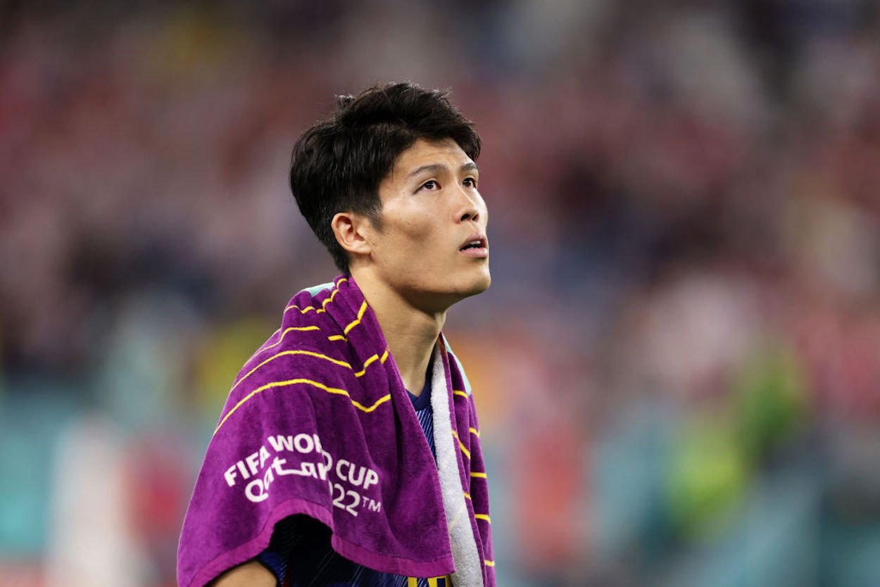 Takehiro Tomiyasu walks off the field after Japan's elimination from the 2022 World Cup.