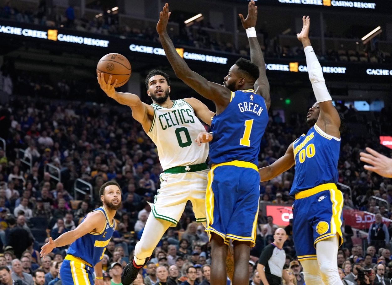 Jayson Tatum of the Boston Celtics shoots over JaMychal Green of the Golden State Warriors.