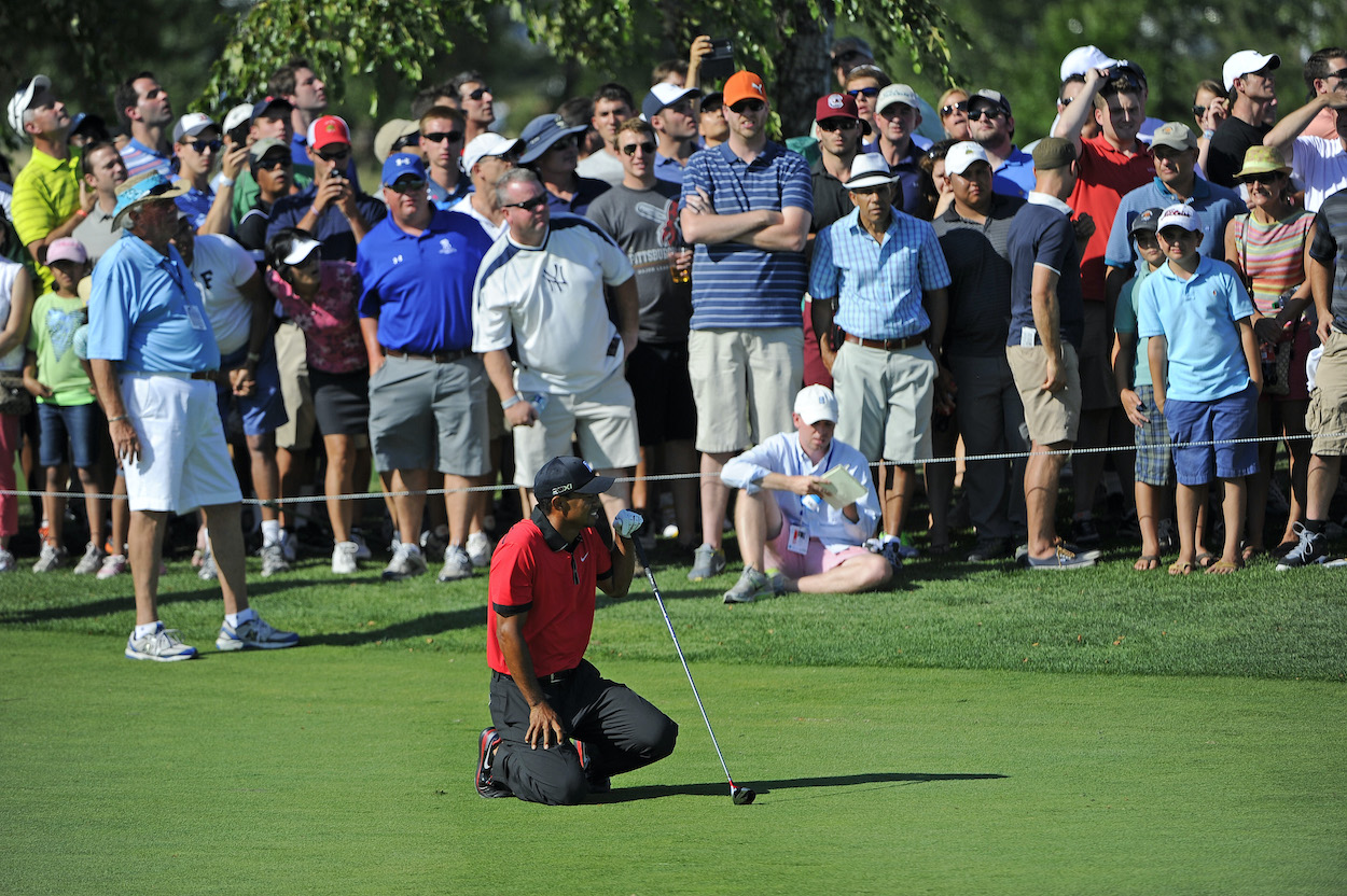 Tiger Woods falls to the ground in pain during the 2013 Barclays.