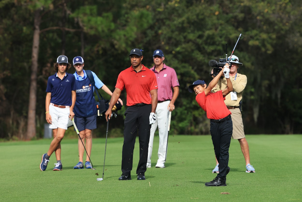 Tiger Woods watches his son, Charlie play a shot.