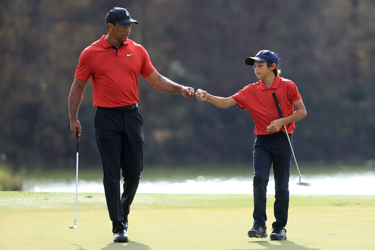 Tiger Woods and his son, Charlie, fist bump during the PNC Championship.