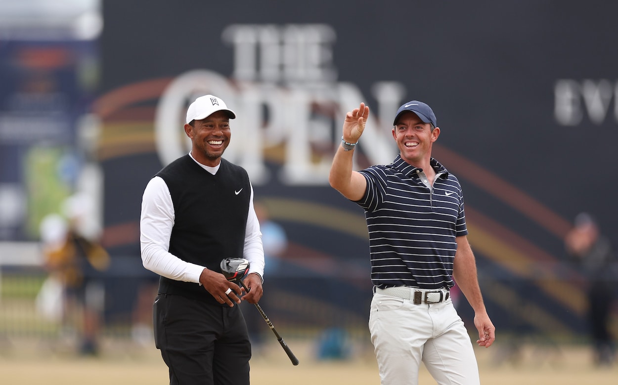 Tiger Woods and Rory McIlroy walk up the fairway.